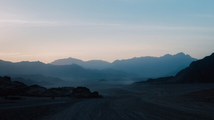 night desert landscape with rocky mountains and sunset sky with clouds in Sharm El Sheikh