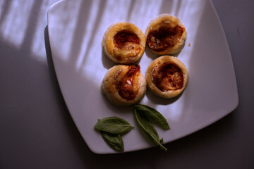 Small Italian pizzas on a white plate.