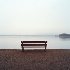 Solitude by the Still Water: A lone bench overlooks a misty lake, inviting quiet contemplation and peaceful reflection