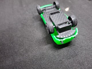 Fototapeta premium Vibrant, soft car toy for babies with engaging lights, sounds, and textures, designed to stimulate sensory development and motor skills.