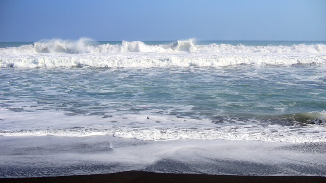 The sea is rough on the white sand beach of the laguna, Kebumen, Central Java Indonesia