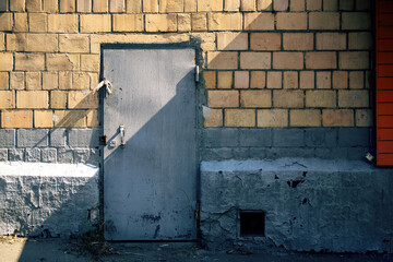 aged metal door, marked by time, features a carved-out section for the lock's tongue. This...