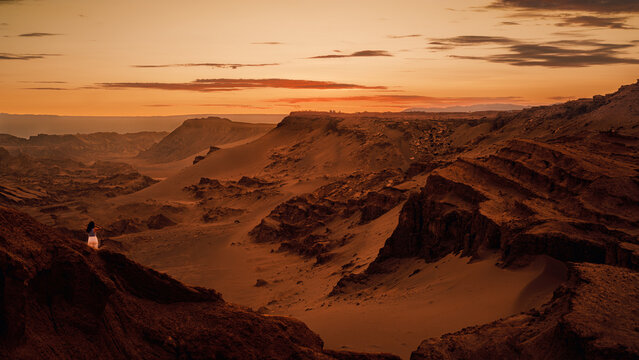 Breathtaking sunset illuminates the unique rock formations and vast sands at Mirador de Kari, showcasing the natural beauty of Moon Valey, San Pedro de Atacama, Chile.
