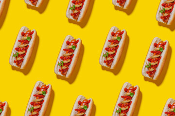 A seamless, eye-catching pattern featuring hot dogs arranged across a bright yellow background