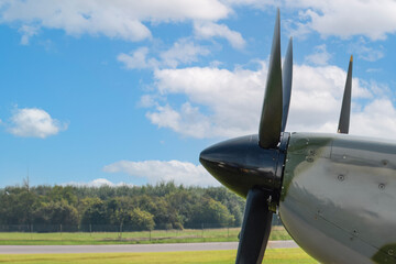 A fragment of the nose of an old propeller plane without engineering detail against a clear sky....