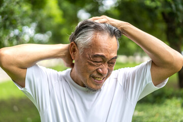 Sick unhappy senior elderly man touching head serious depressed feeling headache thinking of...