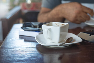 Caucasian man drinking coffee in the outdoor cafe.