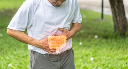 Senior asian elderly man sick unhappy touching belly stomach with suffering from stomach ache pain,...