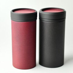 Two cylindrical containers with black lids, one red and one black, with a textured surface.