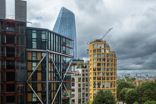 This image features a modern urban skyline with unique buildings, including a distinctive glass structure, offering a view of contemporary architecture and urban development.