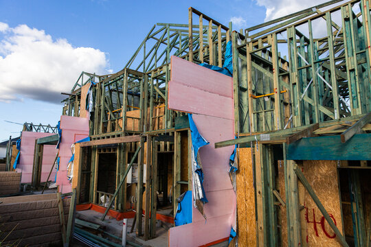 a row of townhouses being built with timber frames