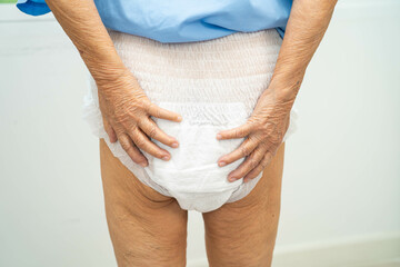 Asian elderly woman wearing diaper for loss of bladder urinary incontinence control.