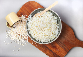 South African Samp or pounded corn on wooden board with cup of raw samp