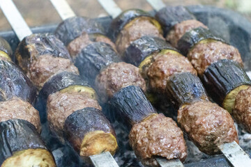 Making eggplant kebab on the barbecue