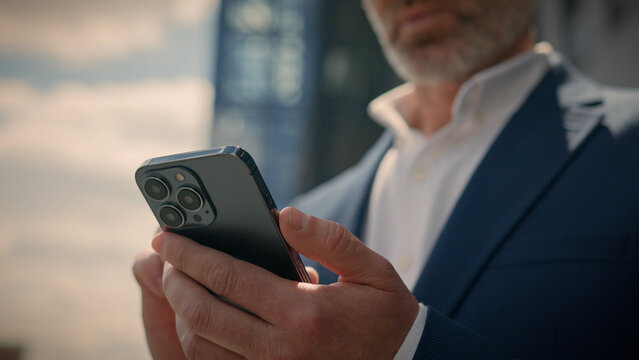 Close up senior business man pensive think problem solution looking at mobile phone in city thoughtful businessman mature entrepreneur elderly employer thinking idea browsing smartphone chat outdoors