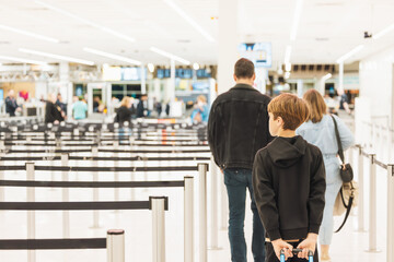 Family walking through security screening at the airport