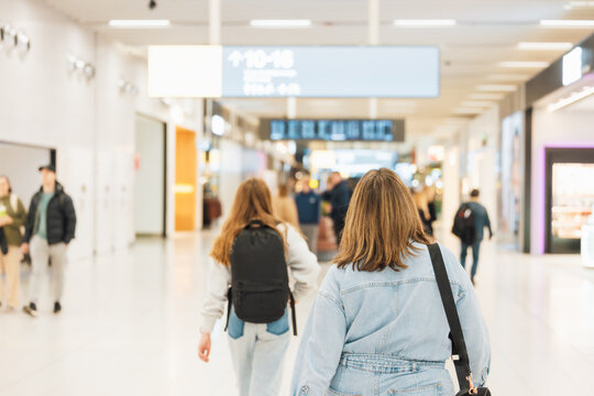 Family walking through airport terminal to catch flight