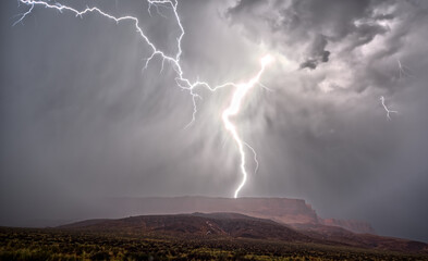 Dramatic lightning strike over Vermilion Cliffs National Monument during the monsoon, Arizona, USA