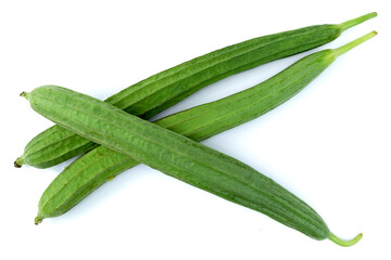 Group of angled luffa, Chinese okra, dish cloth gourd, ridged gourd, or sponge gourd, isolated on white background top view flat lay, stack.