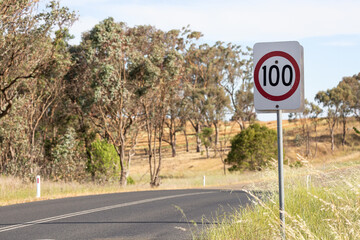 One hundred kilometer speed sign by a rural road