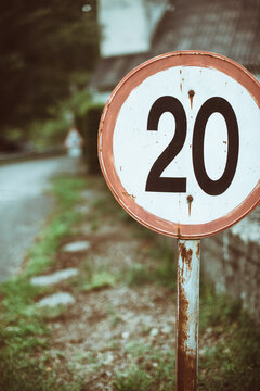Close-up of a 20 miles per hour speed limit sign at the edge of a village, Spain