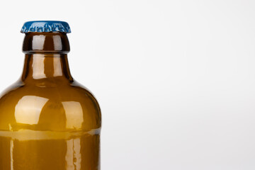 Close-Up of Brown Glass Beer Bottle Neck on Left Side Against White Background, Highlighting...
