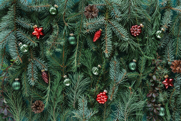 Full frame close-up of assorted Christmas conifer branches with christmas baubles for a festive background