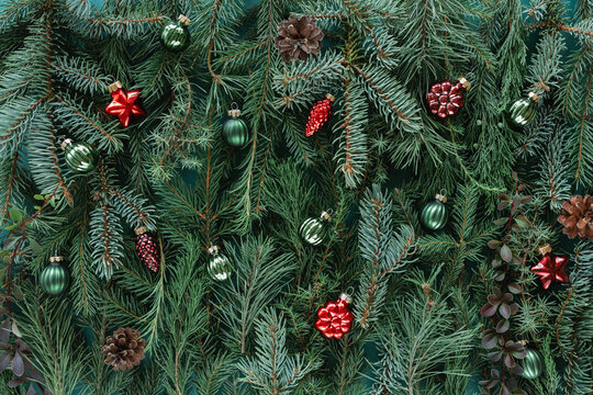 Full frame close-up of assorted Christmas conifer branches with christmas baubles for a festive background