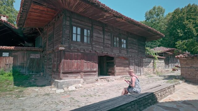Female tourist visits pretty rural Balkan heritage village of Zheravna