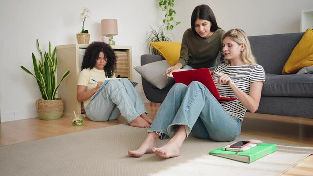 Flatmate student friends studying together using laptop to at home