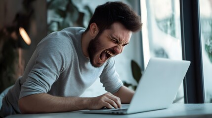 Frustrated man yells at his computer.