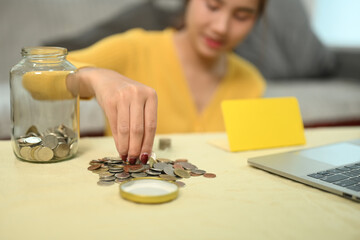 Happy young woman organizing or counting the money. Saving money and financial responsibility concept