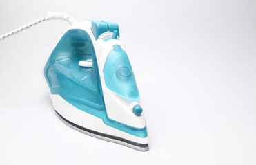 Modern iron for ironing on a white background