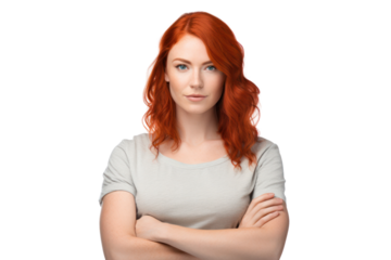 A confident young woman with vibrant red hair standing with crossed arms isolated on white background