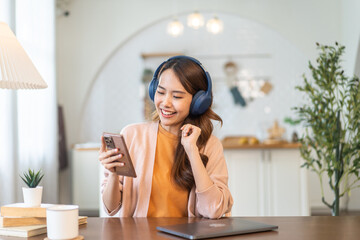 Portrait of smiling happy asian woman relax using digital smartphone.Young asian girl working or study,chatting social network and playing game online or social media,shopping online