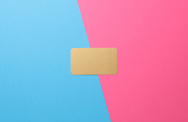 Gold bank card on a blue-pink background