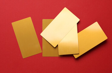 Gold business cards on red background.