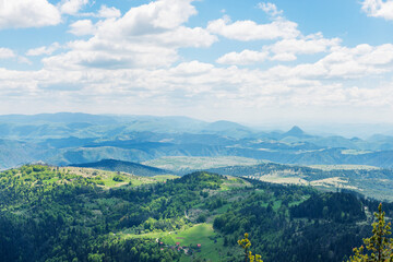 Picturesque mountains near the town of Zlatibor. View of the forest in the mountainous area in summer with blue sky with clouds