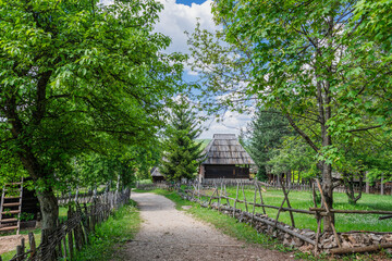 Old wooden houses in Serbian village. Rural landscape in summer