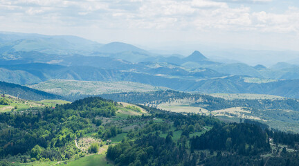 Fototapeta premium Picturesque mountains near the town of Zlatibor. View of the forest in the mountainous area in summer with blue sky with clouds