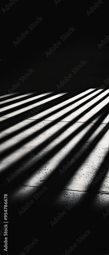 Poster contrast of sharp shadows and light creates an intriguing abstract pattern on a textured surface.