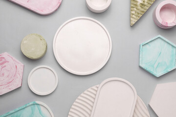 Plaster geometric shapes, trays on a gray background