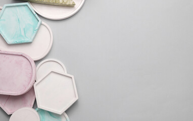 Plaster geometric shapes, trays on a gray background
