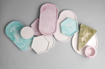 Plaster geometric shapes, trays on a gray background