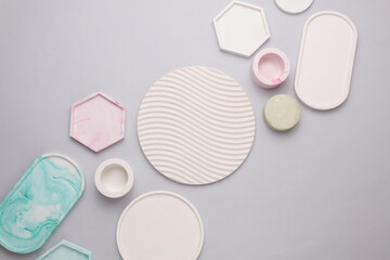 Plaster geometric shapes, trays on a gray background. Top view