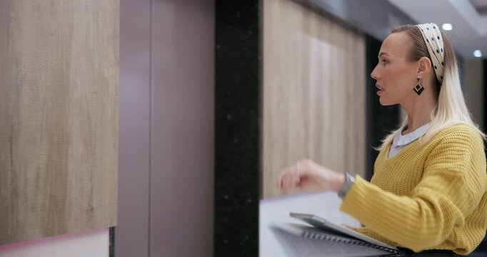 Business, woman and pressing for button by elevator for activating or lift usage and request floor in office building. Female person, worker and waiting in morning by workplace for management career.