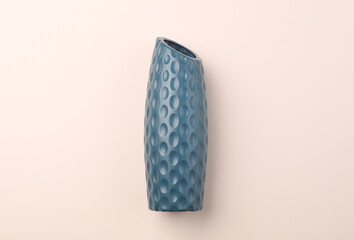 Geometric blue vase in Scandinavian style on a beige background. Top view