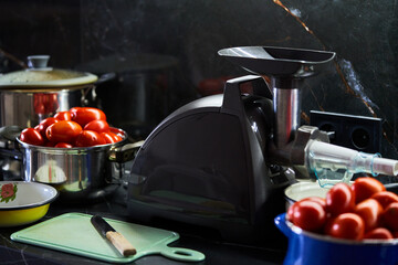 juicer and tomatoes are on the table
