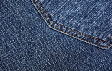 Back pocket of blue jeans close up