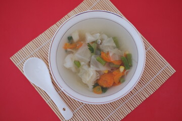 A bowl of vegetable soup on a table